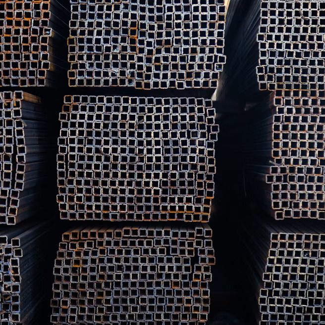 Stacked extruded aluminium bar stock, illustrating Prathamsatya's product range